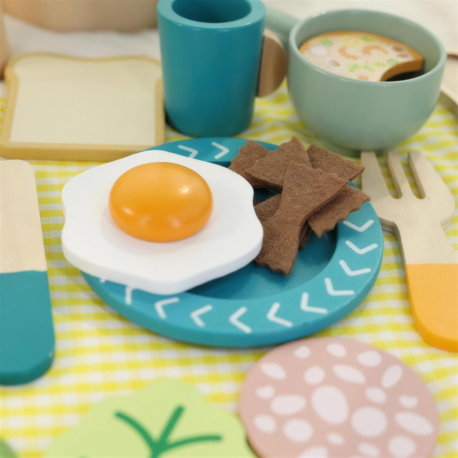 Wooden play egg, bacon and bowl on a plate