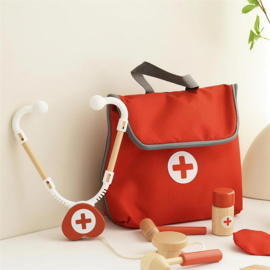 Red doctor bag with wooden stethoscope and medicine bottle