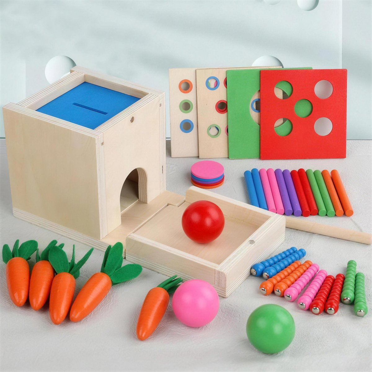 Wooden 6-in-1 object permanence box with carrots, balls, discs and sticks