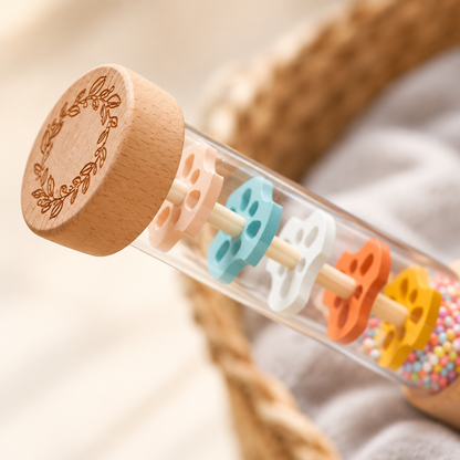 Close-up of colorful beads in the clear rain stick tube